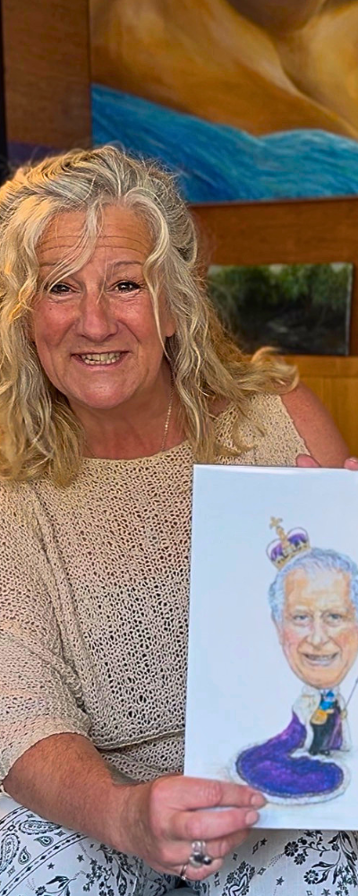 Sadie in her 'imaginarium' Sadie in her artist studio holding a caricature of King Charles