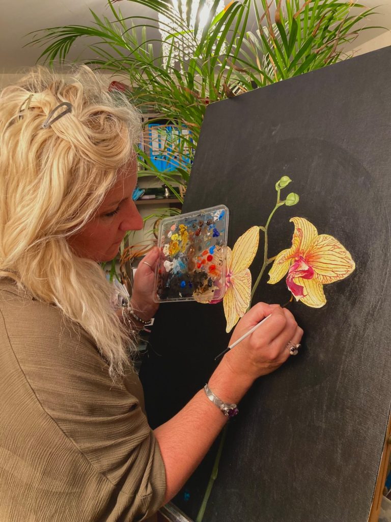 Sadie at work Sadie painting some flowers on a black canvas